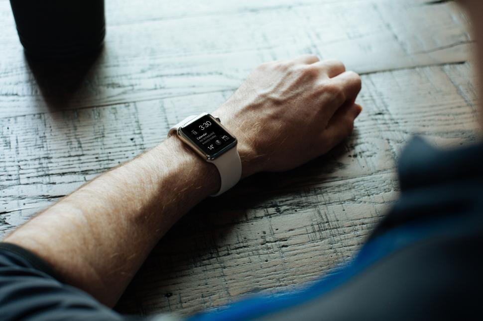Free Image of Man Sitting at Table With Watch on Wrist 