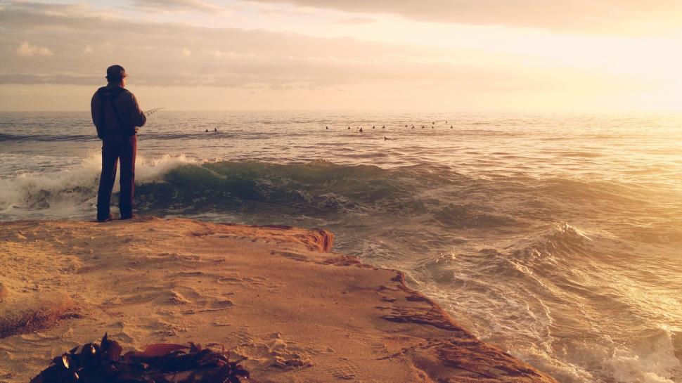 Free Image of Man Standing on Cliff Overlooking Ocean 