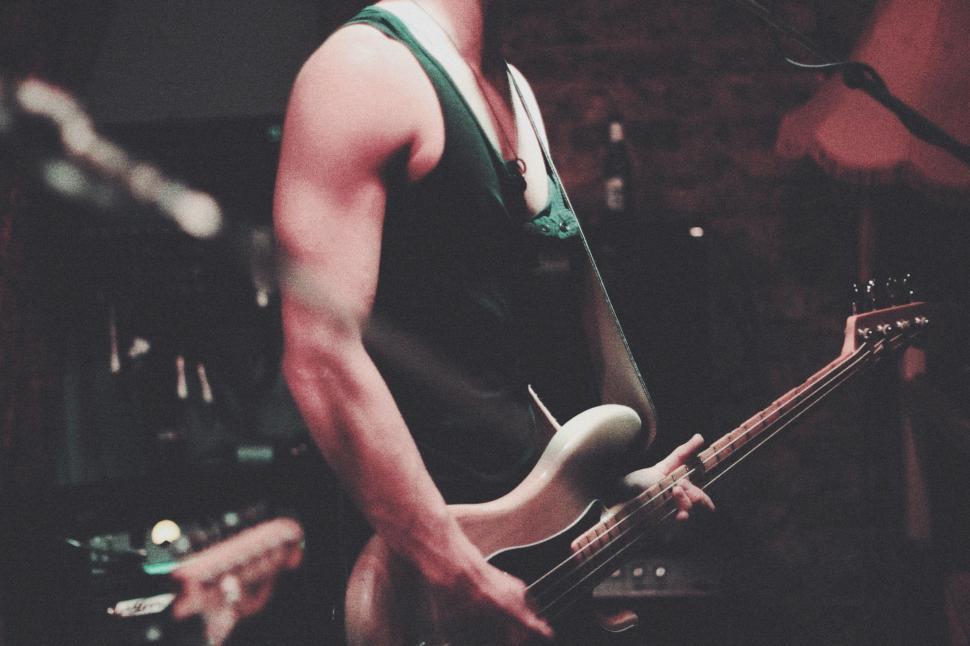 Free Image of Man Playing Guitar in Front of Microphone 