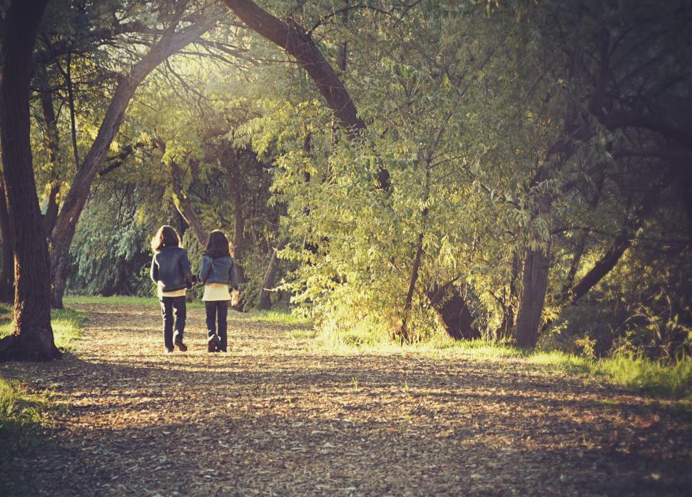 Free Image of People Walking Down a Dirt Road 