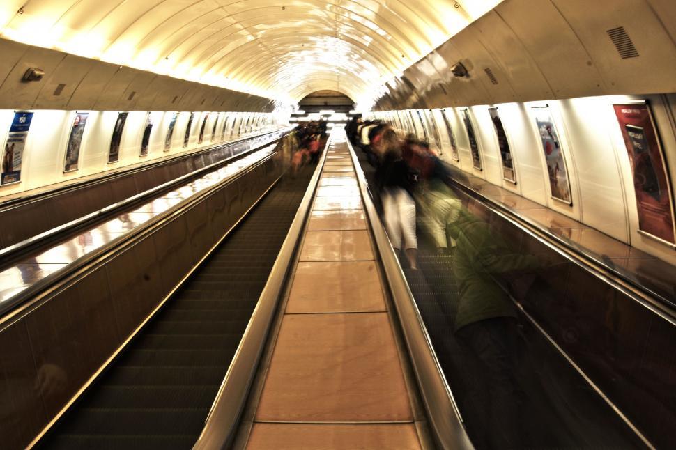 Free Image of Group of People Riding on Top of an Escalator 