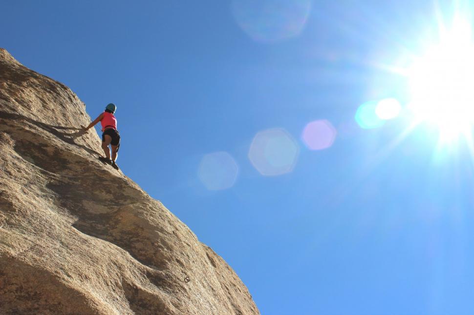 Free Image of Man Climbing Up the Side of a Mountain 