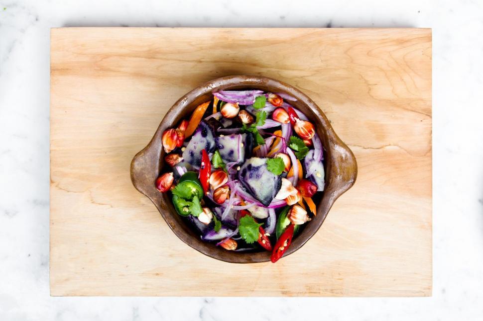 Free Image of Wooden Cutting Board With Bowl of Food 