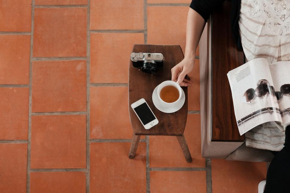 Free Image of Person Sitting at Table With Cup of Coffee 
