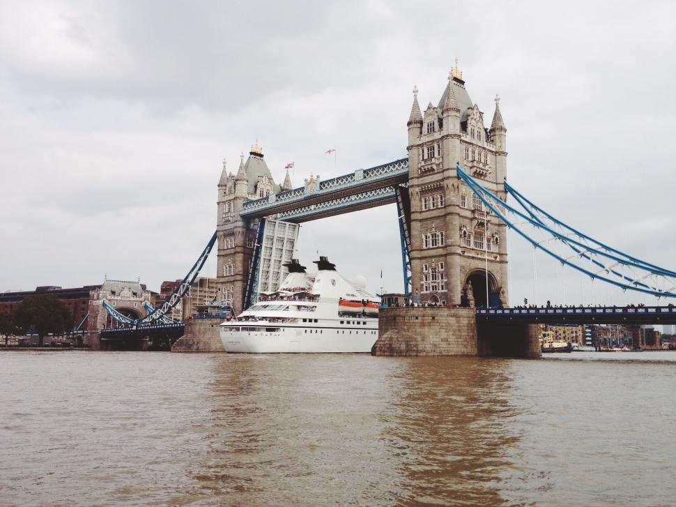 Free Image of Large White Boat Sailing Near Bridge 
