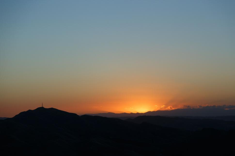 Free Image of Sun Setting Over Mountain Range 