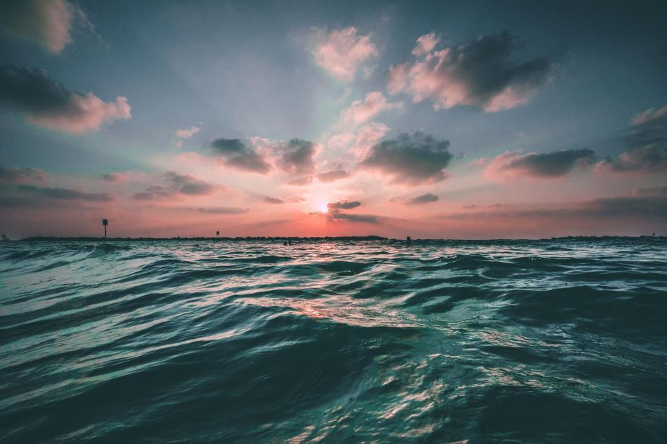 Free Image of Sun Setting Over Body of Water 