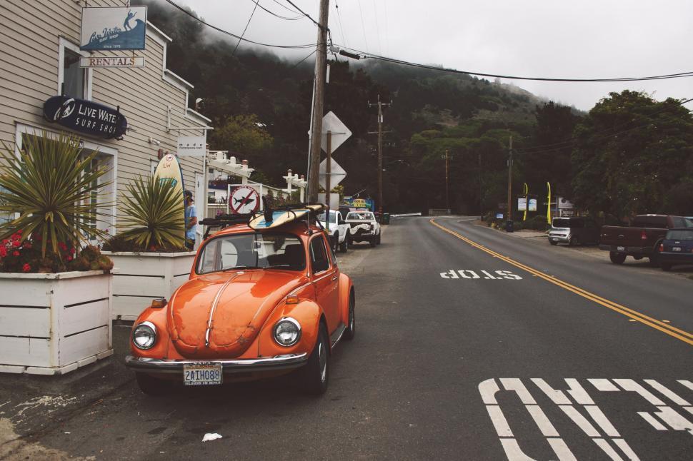 Free Image of Orange Car Parked on Side of Road 
