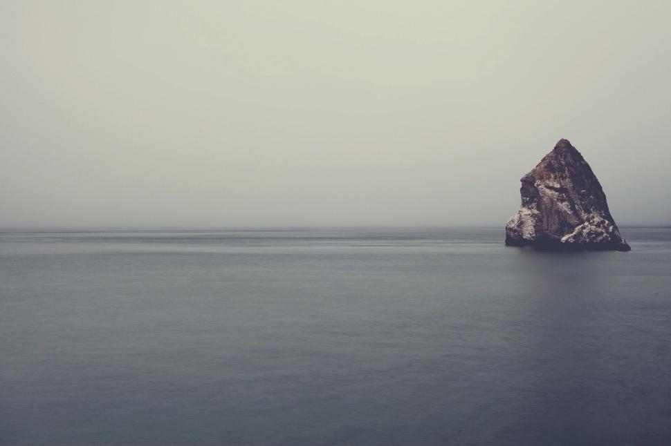 Free Image of Large Rock in Middle of Body of Water 