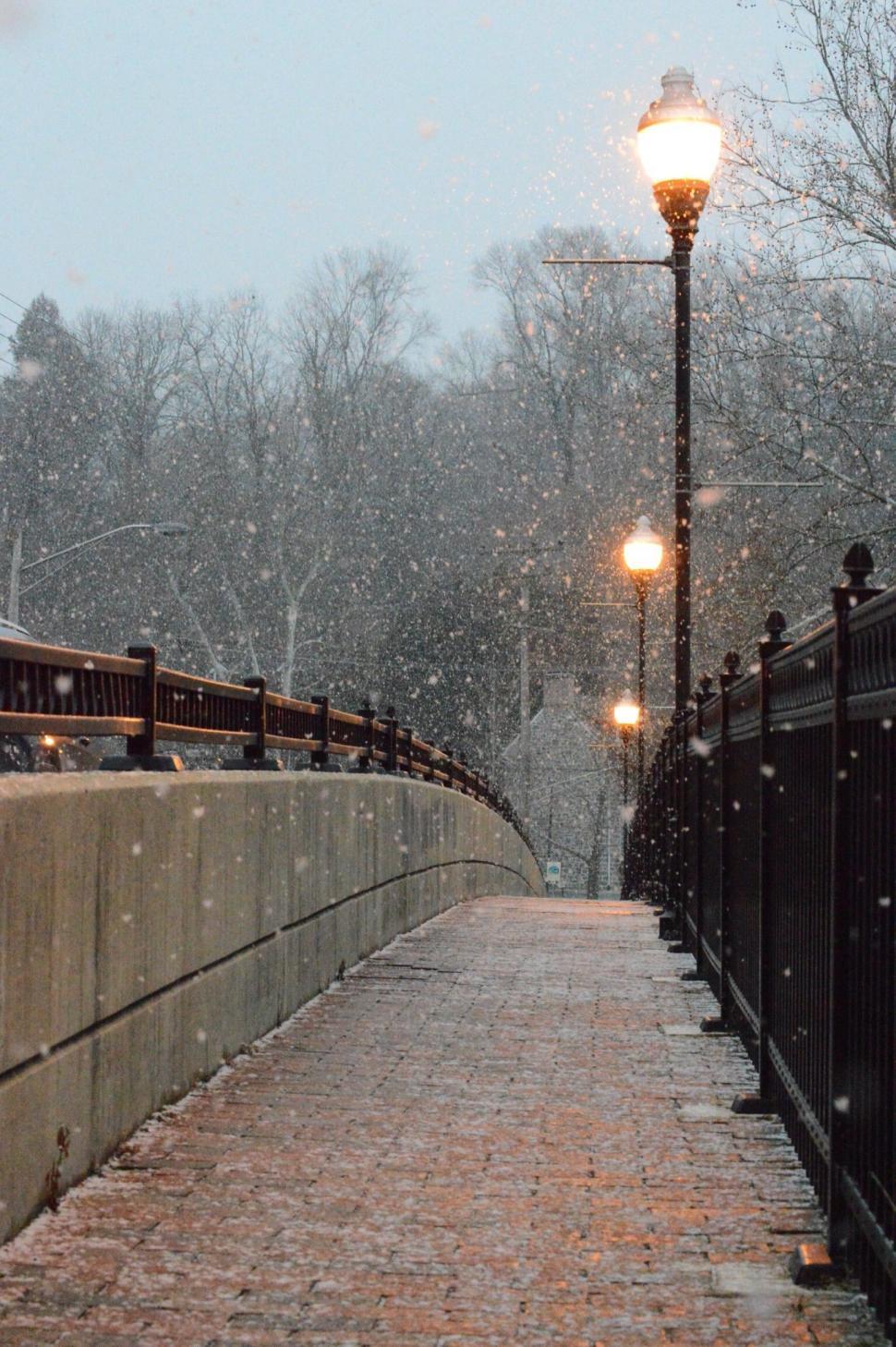 Free Image of Street Light Illuminating Snowy Bridge 