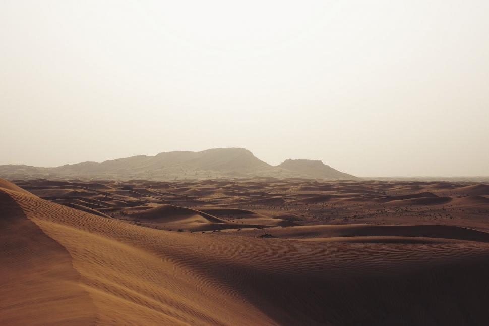 Free Image of Desert Landscape With Sand Dunes and Mountains 