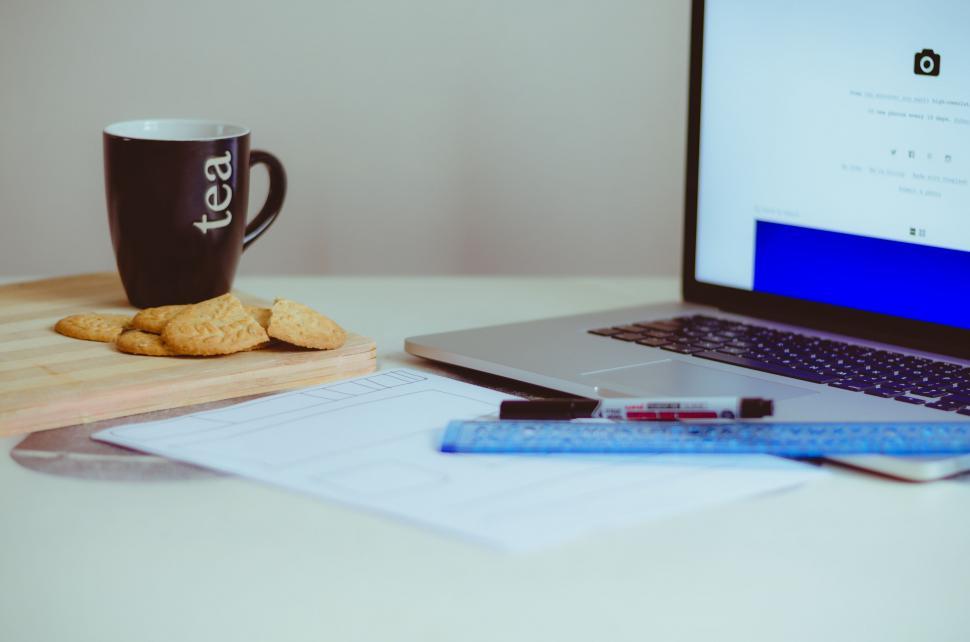 Free Image of Laptop Computer on Desk Next to Coffee Cup 