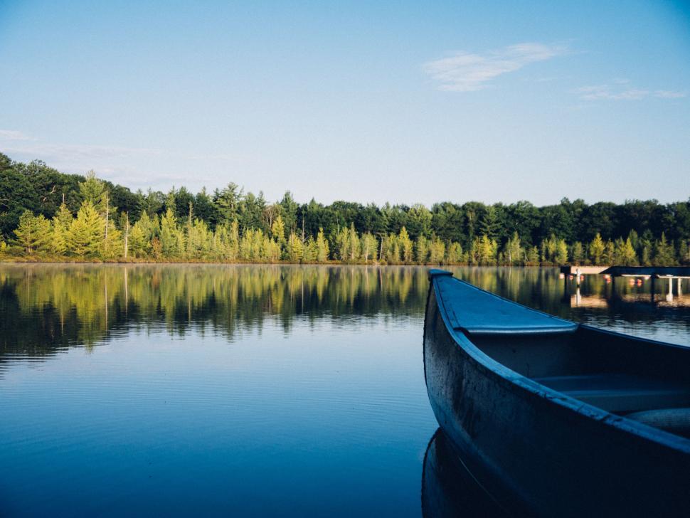Free Image of Boat Docked on Lake Shore by Forest 