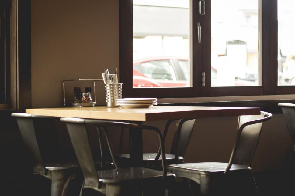 Free Image of Table and Chairs Set in Front of a Window 