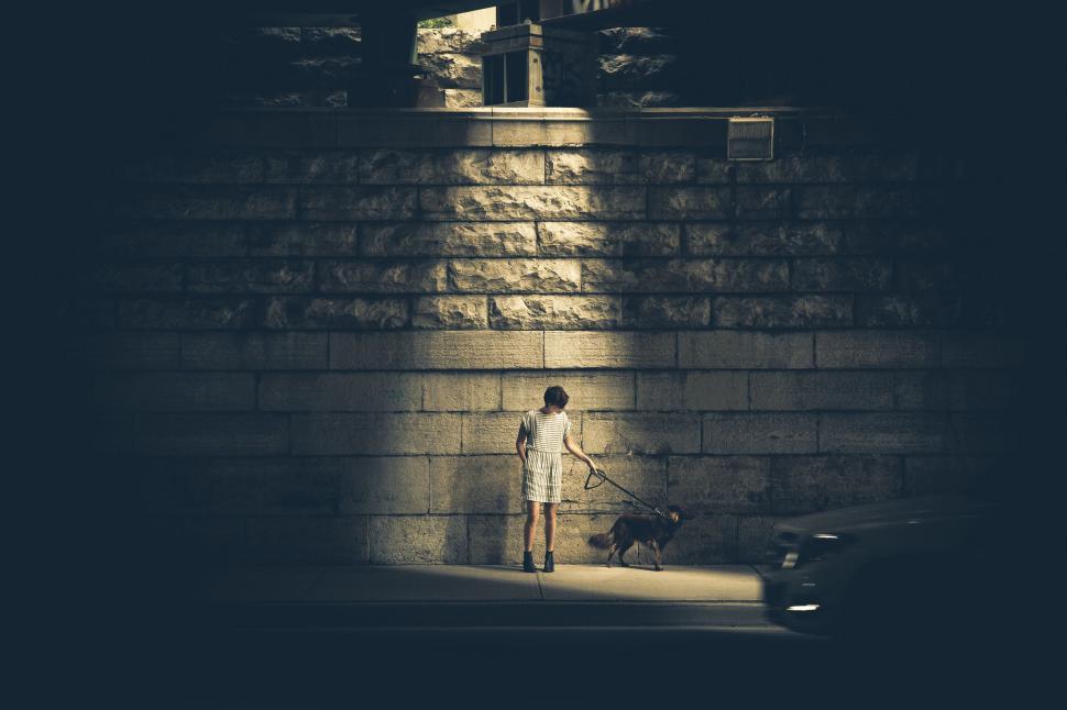 Free Image of Person Standing in Front of Brick Wall 