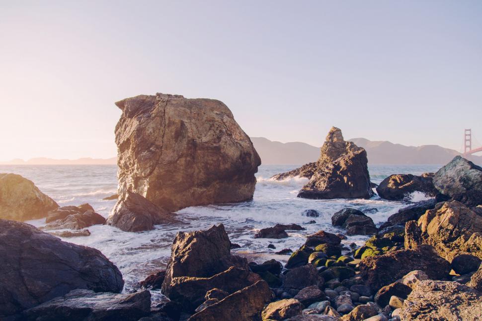 Free Image of Person Standing on Rocky Beach by the Ocean 
