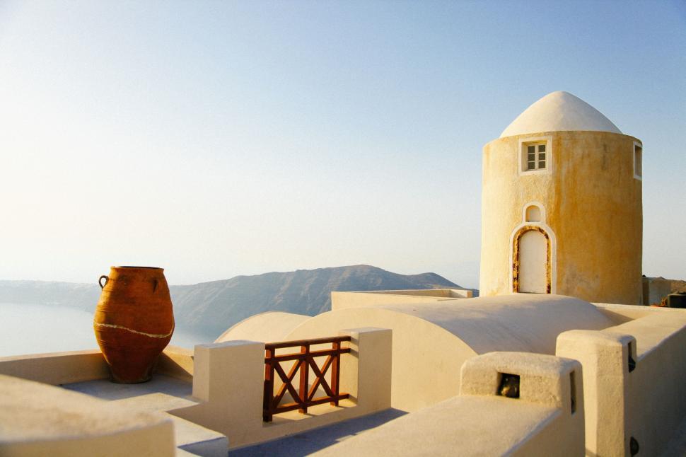 Free Image of Brown Vase Atop White Building 