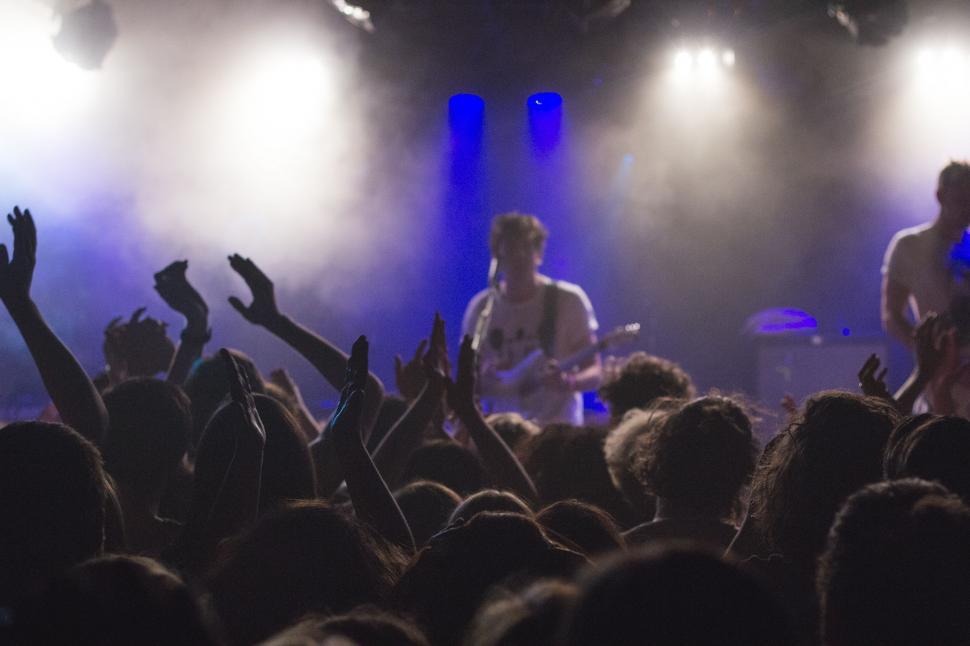 Free Image of Group of People Standing on Top of a Stage 