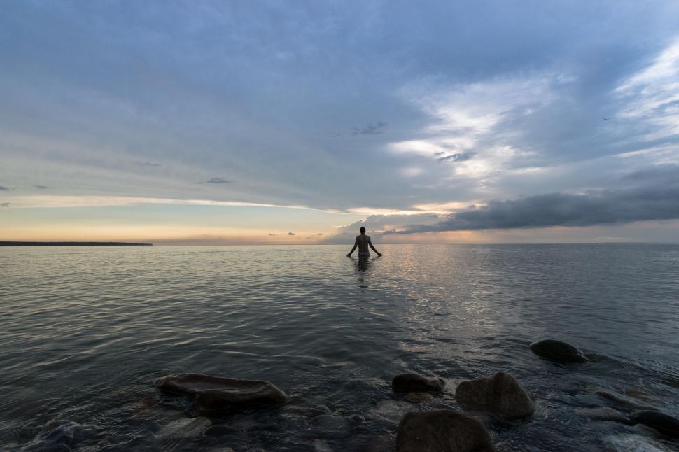 Free Image of Person Standing in Middle of Body of Water 