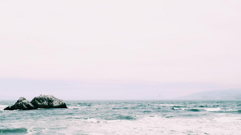 Free Image of Large Rock in Middle of Body of Water 