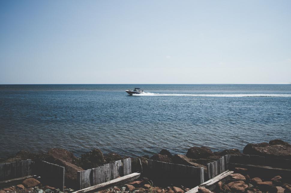 Free Image of Small Boat Sailing on Water 