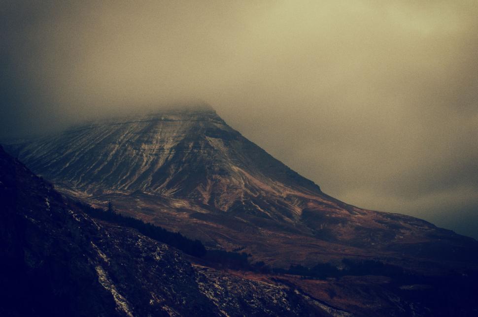 Free Image of Majestic Snow-Covered Mountain Under Cloudy Sky 