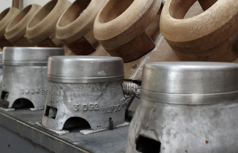 Free Image of Row of Metal Vases on Machine 
