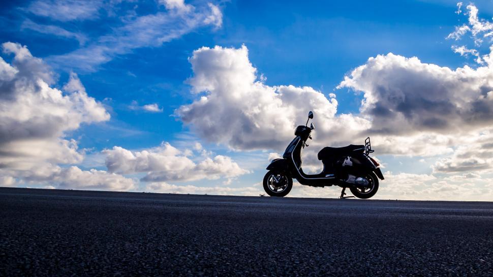 Free Image of Motor Scooter Parked on Side of Road 