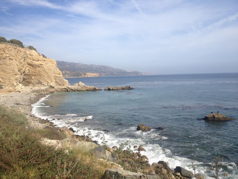 Free Image of A Glimpse of the Ocean From a Cliff 