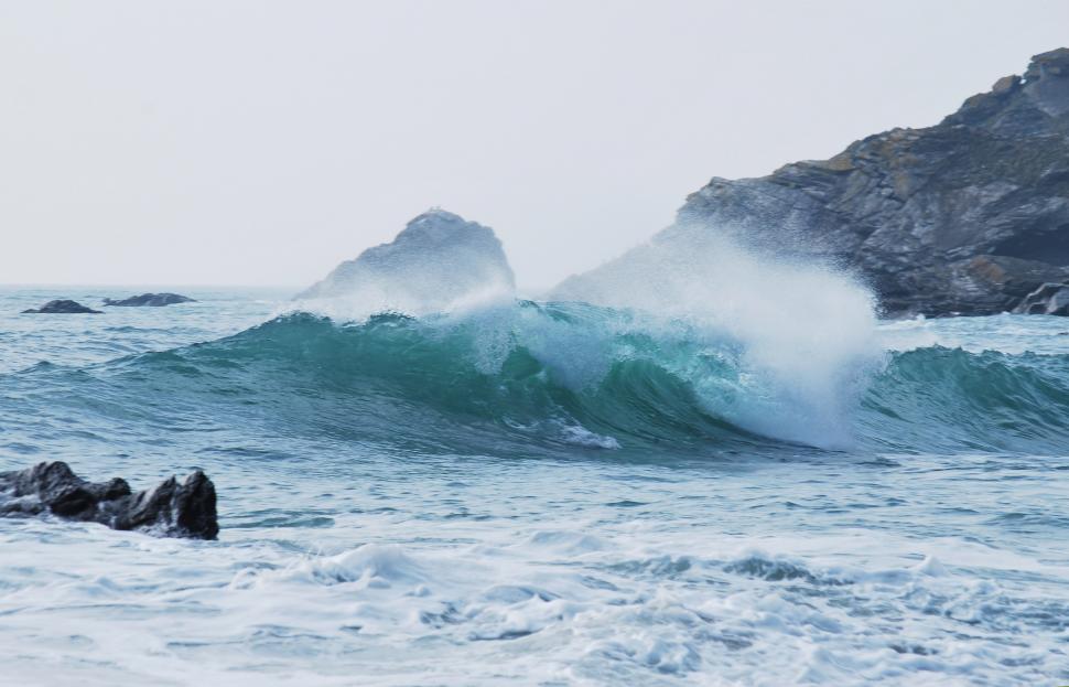 Free Image of A Large Body of Water Surrounded by Rocks 