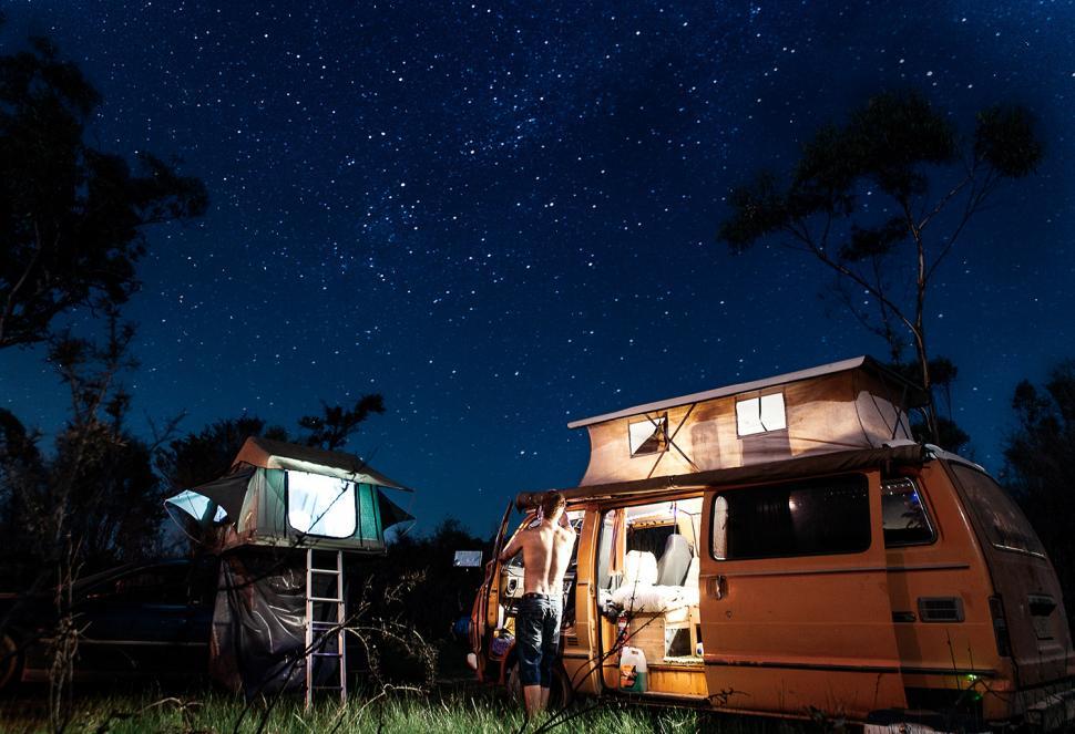 Free Image of Couple Standing Outside Camper 