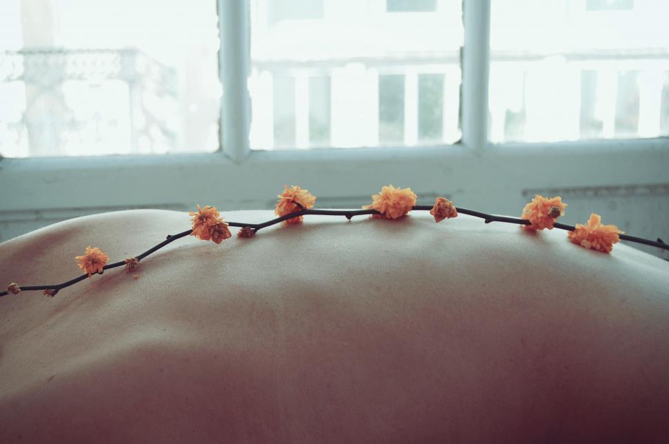 Free Image of Womans Back With Flowers 