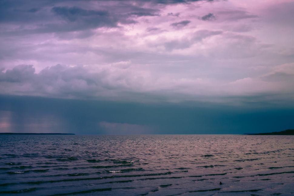 Free Image of Large Body of Water Under Cloudy Sky 