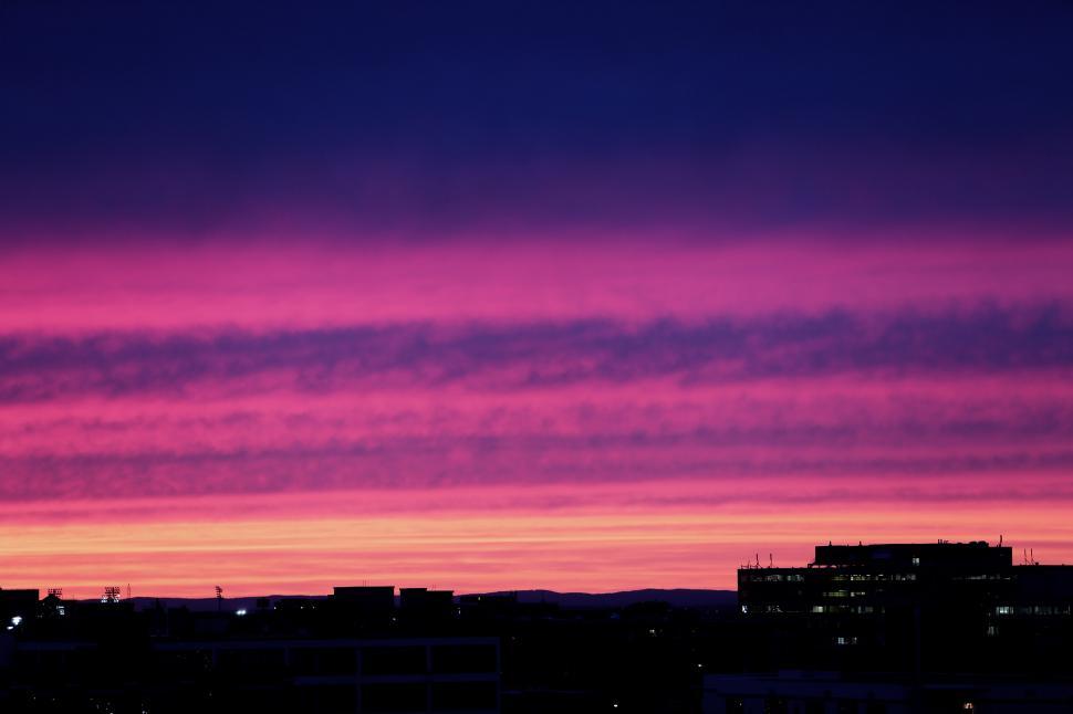 Free Image of City Skyline Silhouetted Against Sunset 