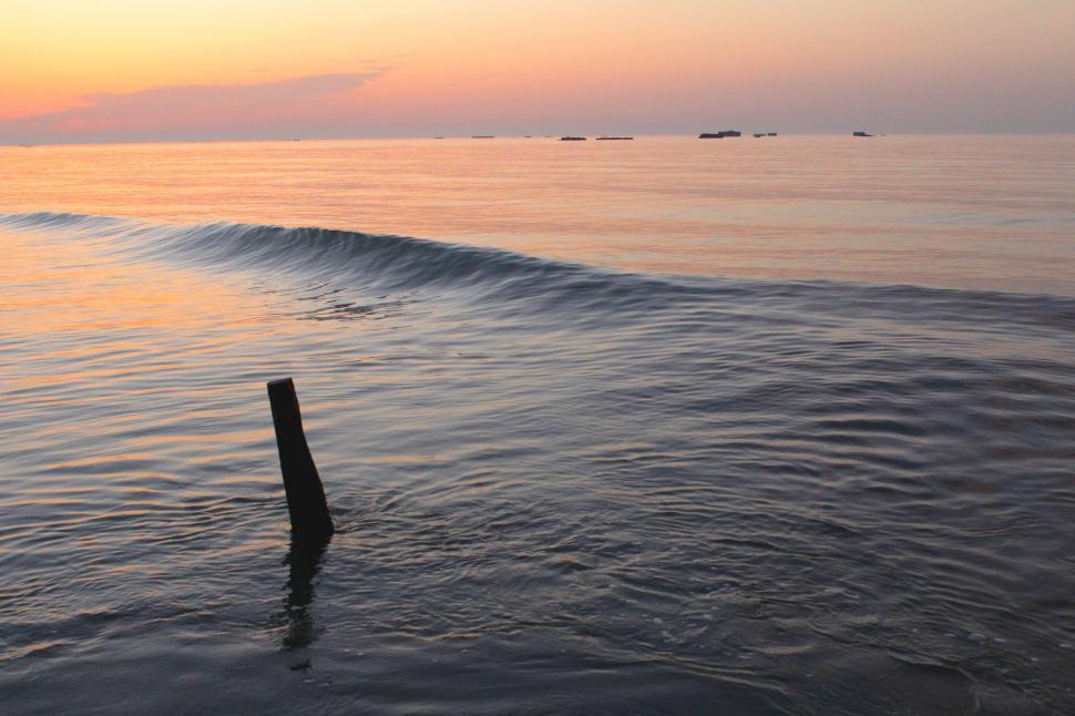 Free Image of Wooden Post in Large Body of Water 