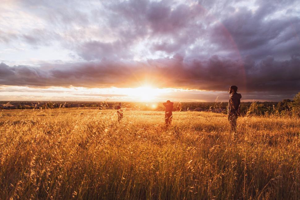 Free Image of Couple Walking Across Grass Covered Field 
