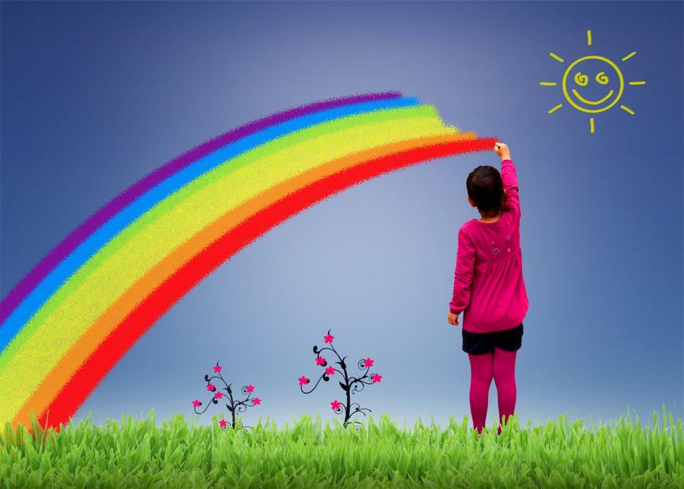 Free Image of Little girl painting a rainbow on the sky 