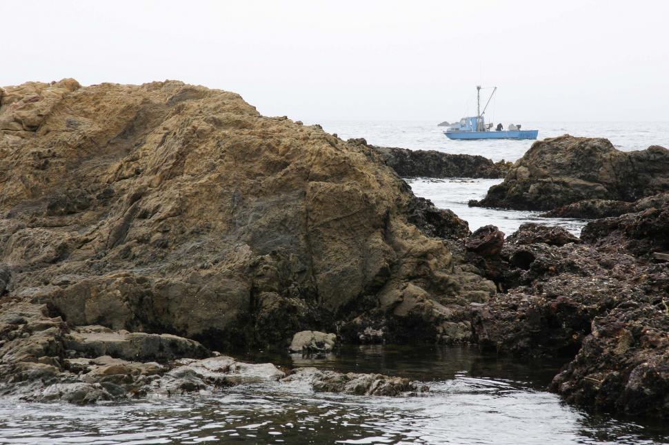 Free Image of Boat beyond the rocks 