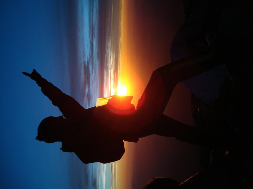 Free Image of Person Standing in Front of Window at Sunset 