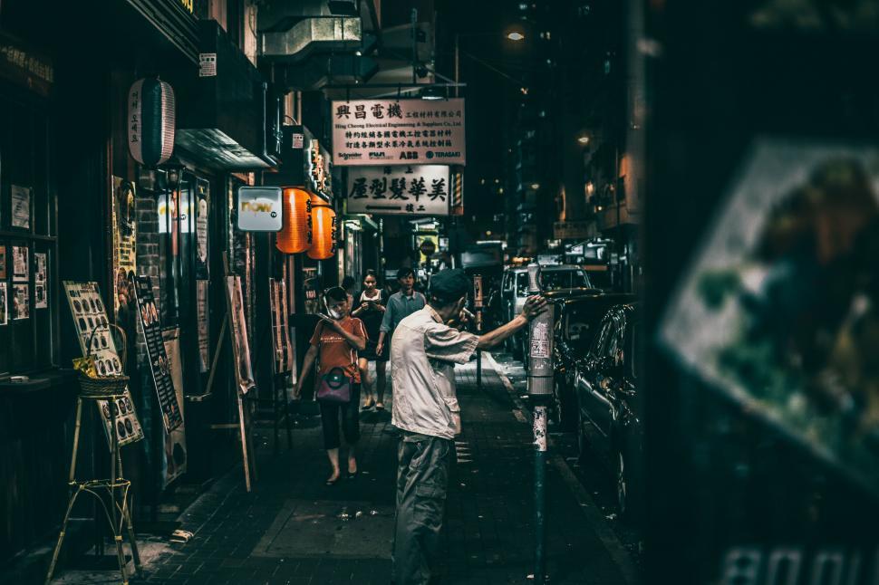 Free Image of Man Walking Down a Dark Alleyway 