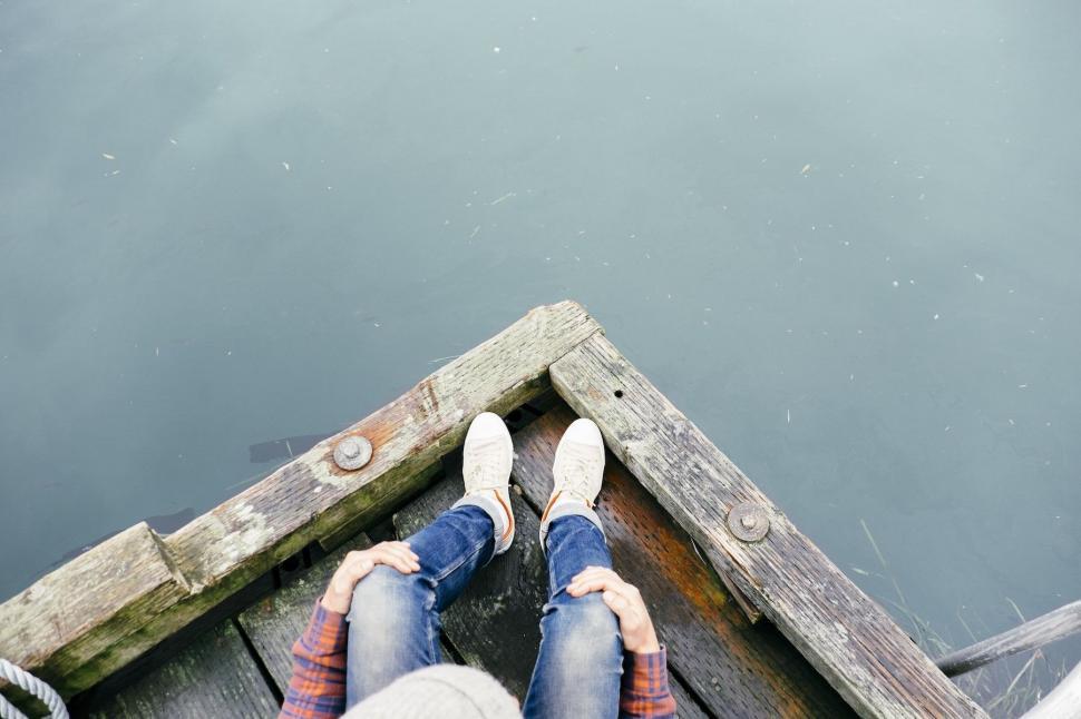 Free Image of Person Standing on Dock With Feet Up 