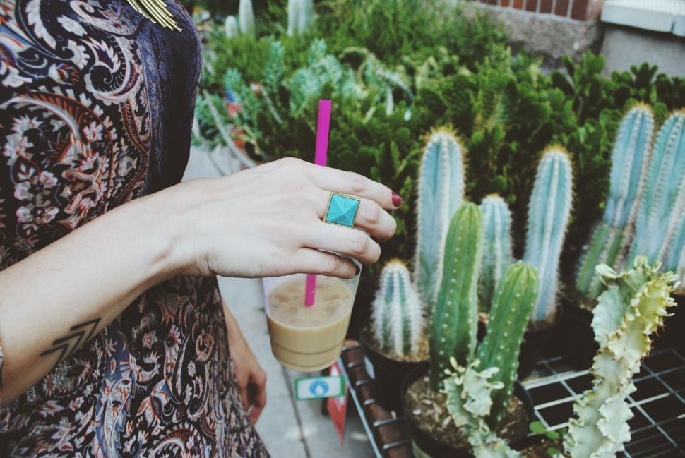Free Image of Woman Holding a Drink in Her Hand 