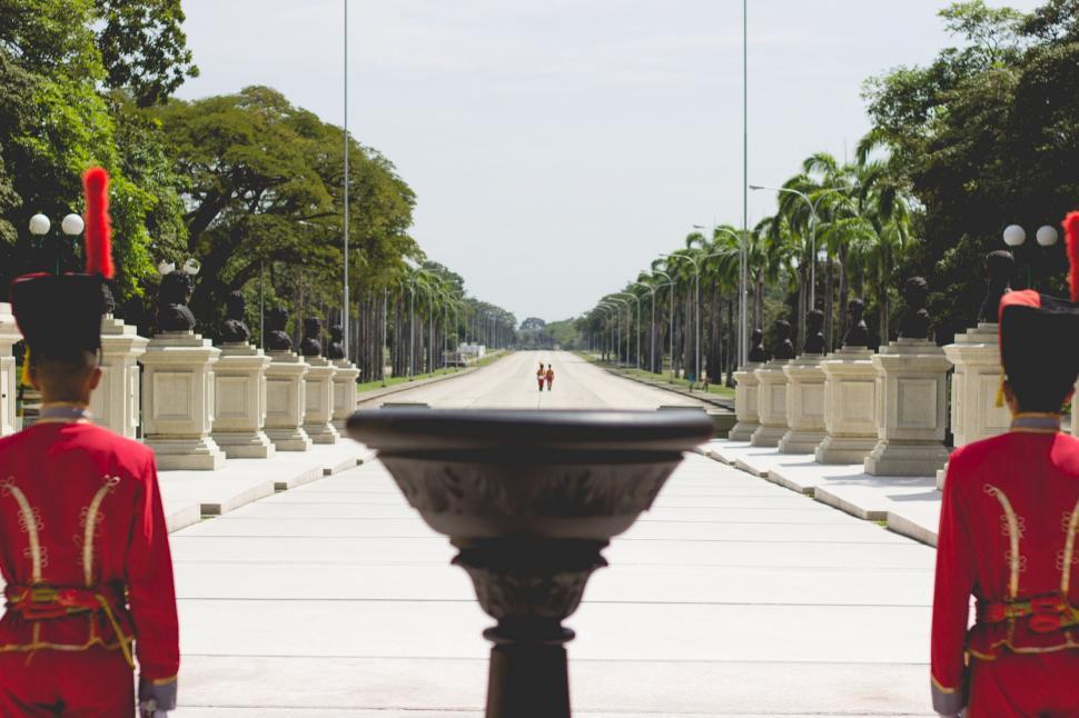 Free Image of Men in Red Uniforms by Fountain 