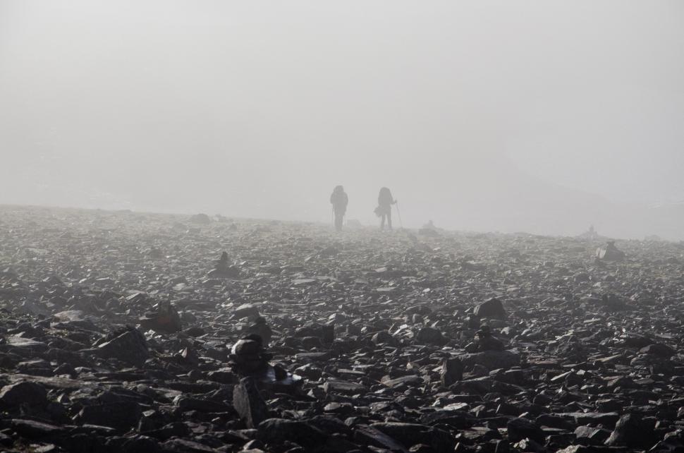 Free Image of Two People Standing on a Hill 