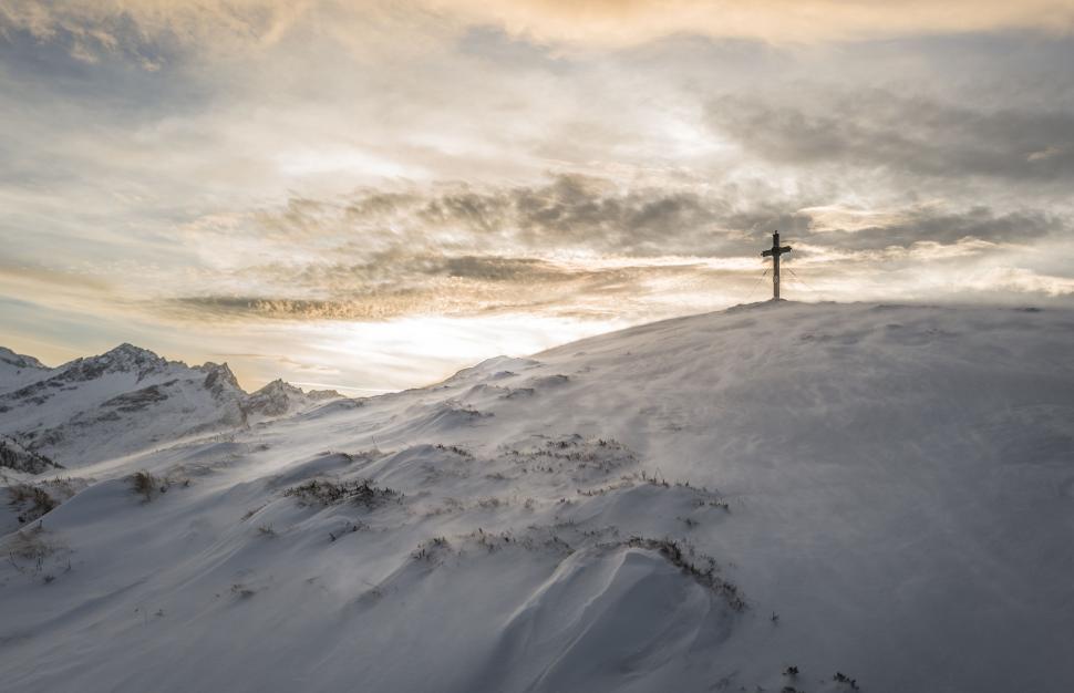 Free Image of Person Standing on Top of Snow Covered Mountain 