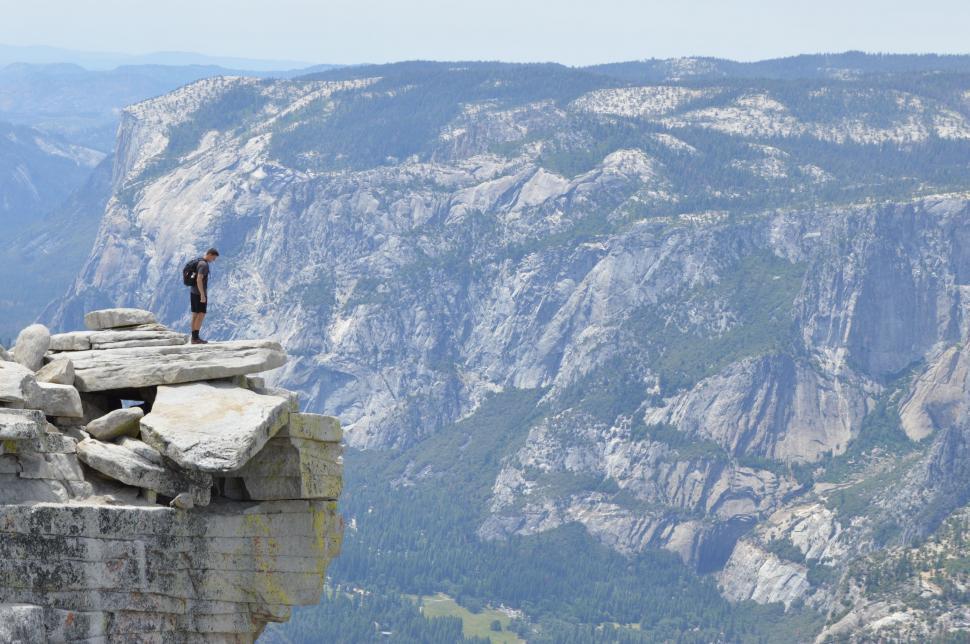 Free Image of Man Standing on Top of Cliff 