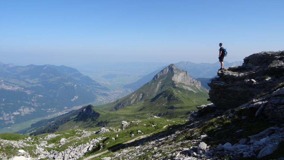 Free Image of Man Standing on Top of a Mountain 