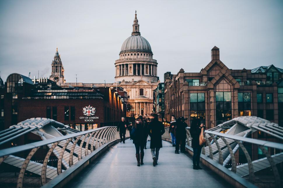 Free Image of Group of People Walking Across a Bridge 