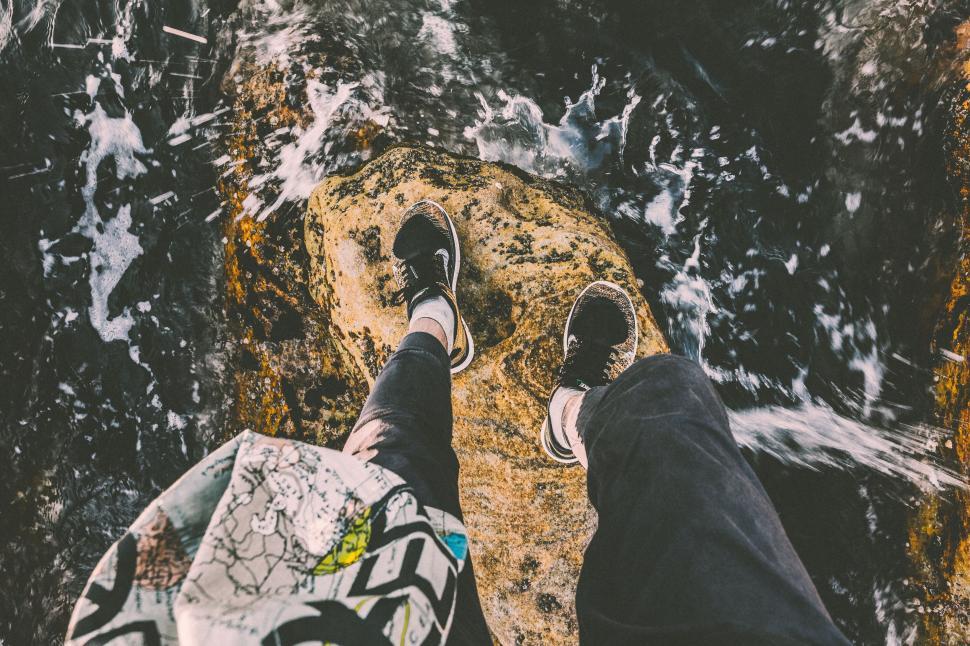 Free Image of Person Standing on Rock Near Water 
