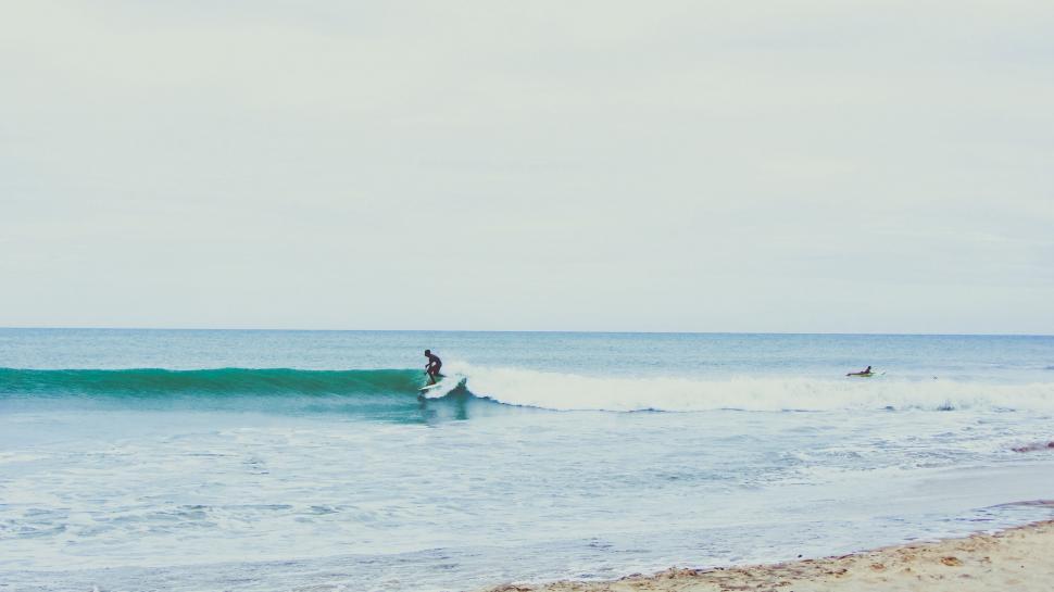 Free Image of Man Riding Wave on Surfboard 
